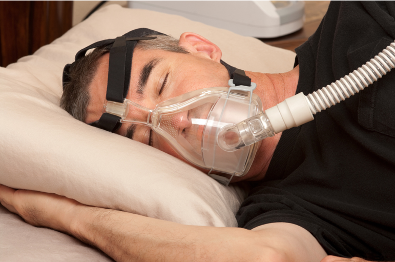 man sleeping with cpap